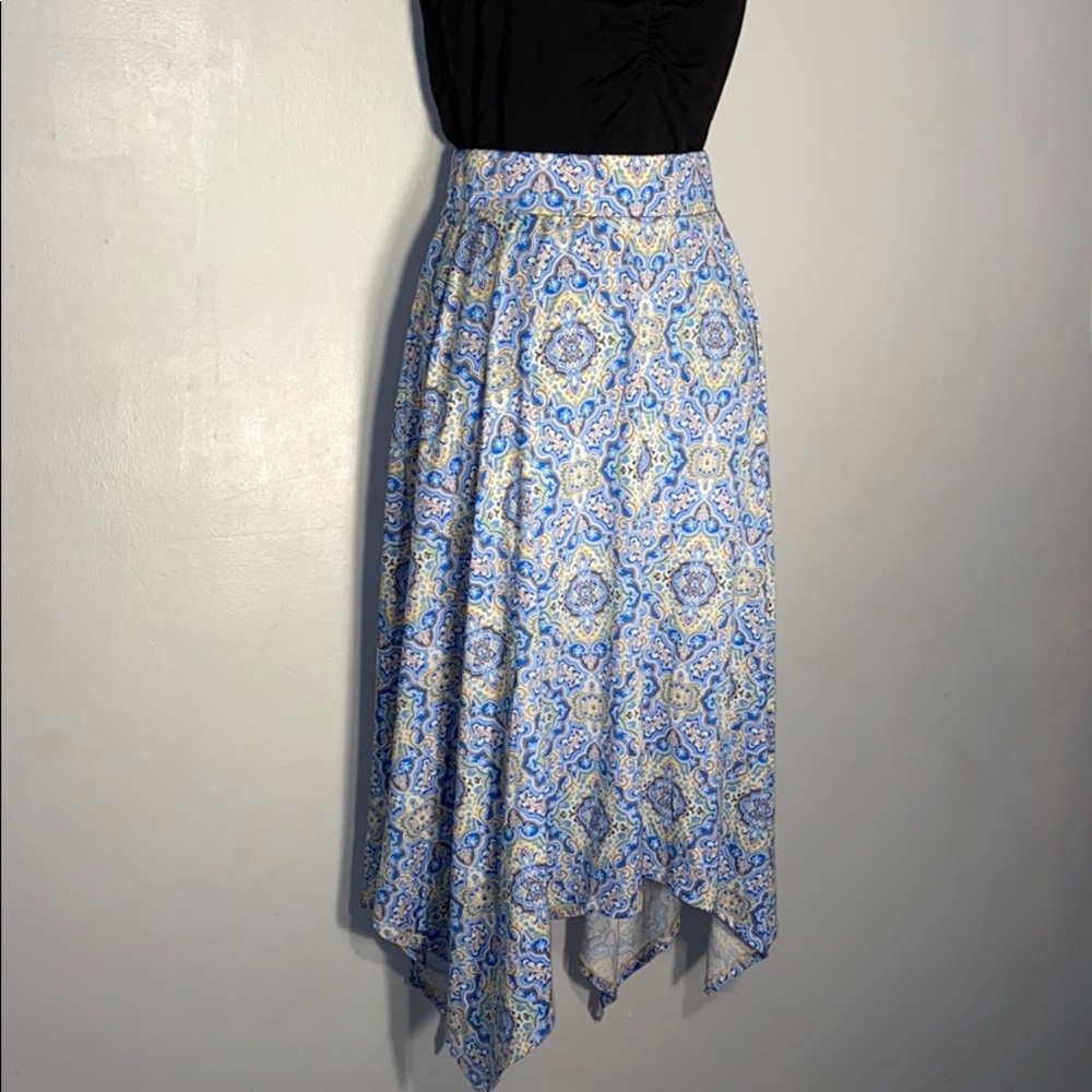100% poly knit skirt with handkerchief hem.